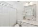 Well-lit bathroom with a white vanity, decorative mirror, and a shower with a curtain at 1651 Valley Oak Rd, Johns Island, SC 29455