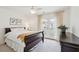 Bright bedroom with carpet, ceiling fan, a large window, and a comfortable bed at 1651 Valley Oak Rd, Johns Island, SC 29455