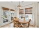 Bright dining room featuring a wooden table, chandelier lighting, and natural light from a glass patio door at 1651 Valley Oak Rd, Johns Island, SC 29455
