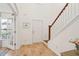 Bright, open foyer with hardwood floors, a staircase, and a glimpse of the outdoors at 1651 Valley Oak Rd, Johns Island, SC 29455