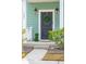 Welcoming front door with a green wreath, stylish lighting, and manicured landscaping at 1651 Valley Oak Rd, Johns Island, SC 29455