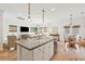 Bright, open kitchen with an island, bar seating, stainless appliances, and access to both the living and dining areas at 1651 Valley Oak Rd, Johns Island, SC 29455