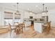 Bright kitchen featuring a breakfast nook, stainless steel appliances, white cabinetry, and access to the dining area at 1651 Valley Oak Rd, Johns Island, SC 29455