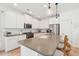 Kitchen features a large center island with seating, stainless steel appliances, and white subway tile backsplash at 1651 Valley Oak Rd, Johns Island, SC 29455