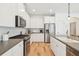 Spacious kitchen featuring stainless steel appliances, white cabinets, and an island with sink at 1651 Valley Oak Rd, Johns Island, SC 29455