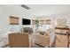 Bright living room featuring hardwood floors, a large sofa, a patterned rug, and modern entertainment center at 1651 Valley Oak Rd, Johns Island, SC 29455