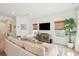 Spacious living room featuring hardwood floors, a large sofa, a patterned rug, and modern entertainment center at 1651 Valley Oak Rd, Johns Island, SC 29455