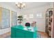 Stylish office with a unique green desk, ample lighting, and decorative bookshelves at 1651 Valley Oak Rd, Johns Island, SC 29455