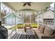 Screened-in porch with comfortable seating, a ceiling fan, and views of the backyard and neighboring homes at 1651 Valley Oak Rd, Johns Island, SC 29455