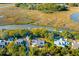 Stunning aerial view of a home with river access and a private dock nestled among lush greenery at 178 Beresford Creek St, Daniel Island, SC 29492