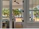 Covered back porch featuring wicker furniture, ceiling fan and view of waterfront at 178 Beresford Creek St, Daniel Island, SC 29492