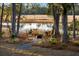 Cozy backyard fire pit area with rocking chairs, perfect for enjoying evenings outdoors by the waterway at 178 Beresford Creek St, Daniel Island, SC 29492