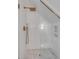 Stylish bathroom shower featuring gold hardware, white tile and hexagon flooring at 178 Beresford Creek St, Daniel Island, SC 29492