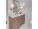 Elegant bathroom showcasing wood vanity with gold fixtures, complemented by stylish mirror and modern lighting at 178 Beresford Creek St, Daniel Island, SC 29492