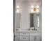 Elegant bathroom showcasing double vanity with gold-framed mirrors and modern lighting fixtures, enhancing its sophisticated design at 178 Beresford Creek St, Daniel Island, SC 29492