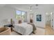 Bright bedroom featuring a queen-size bed, ceiling fan, and view through window, creating a peaceful space at 178 Beresford Creek St, Daniel Island, SC 29492