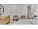 Bright bedroom with light hardwood floors, a decorative mirror and comfortable seating at 178 Beresford Creek St, Daniel Island, SC 29492