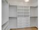 Custom walk-in closet featuring adjustable shelving and drawer units with sleek hardware, creating a streamlined design at 178 Beresford Creek St, Daniel Island, SC 29492