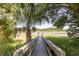 Scenic dock view with a palm tree and surrounding marsh leading to serene waterway at 178 Beresford Creek St, Daniel Island, SC 29492