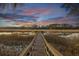 Long wooden dock stretching out into the tranquil waterway, ideal for boating and enjoying the sunset at 178 Beresford Creek St, Daniel Island, SC 29492