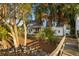 Exterior of a charming coastal home with palm trees, a covered porch, and access to the marsh at 178 Beresford Creek St, Daniel Island, SC 29492