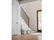 Inviting foyer featuring modern staircase with iron railings and a glass front door, creating a stylish entrance at 178 Beresford Creek St, Daniel Island, SC 29492