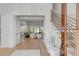 Bright, airy foyer with wood floors, staircase, and view into the living room at 178 Beresford Creek St, Daniel Island, SC 29492