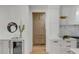 Bright kitchen with white cabinets, stainless appliances, pantry and hardwood floors at 178 Beresford Creek St, Daniel Island, SC 29492