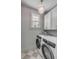 Laundry room with a washer and dryer set, white cabinets, and a window at 178 Beresford Creek St, Daniel Island, SC 29492