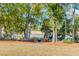 Outdoor seating area with rocking chairs around a fire pit, nestled in a yard near a lake at 178 Beresford Creek St, Daniel Island, SC 29492