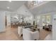 Open-concept living area with a fireplace, bright kitchen, and access to the outdoors at 178 Beresford Creek St, Daniel Island, SC 29492