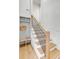 Stylish staircase with wooden stairs, black metal railing, and built-in storage at 178 Beresford Creek St, Daniel Island, SC 29492