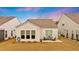 Landscaped backyard featuring a cozy patio with seating, surrounded by lush greenery at 178 Garden Gate Way, Summerville, SC 29486