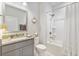 Well-lit bathroom featuring granite counters, grey cabinets, shower over tub, and elegant fixtures at 178 Garden Gate Way, Summerville, SC 29486