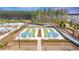Aerial view of bocce ball courts with shade canopies alongside a luxurious community pool at 178 Garden Gate Way, Summerville, SC 29486