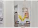 Charming dining area features a modern light fixture, a wooden table, and a partial view of the stainless fridge at 178 Garden Gate Way, Summerville, SC 29486