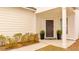 A well-decorated front porch featuring potted plants, manicured bushes, and a stylish welcome mat at the entrance at 178 Garden Gate Way, Summerville, SC 29486