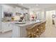 Bright kitchen boasts white cabinets, granite countertops, stainless steel appliances, and counter seating at 178 Garden Gate Way, Summerville, SC 29486