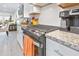 Modern kitchen featuring sleek appliances, white cabinetry, granite countertops, and a view into the adjoining dining area at 178 Garden Gate Way, Summerville, SC 29486