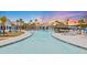 Resort-style community pool featuring palm trees, lounge areas, and inviting water features at 178 Garden Gate Way, Summerville, SC 29486