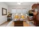 Bright sitting room with comfortable couch, natural lighting, and a classic hutch desk at 178 Garden Gate Way, Summerville, SC 29486