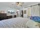 Spacious bedroom with dark wood furniture, TV, and a sliding barn door to closet at 1861 Jaywood Cir, Charleston, SC 29407