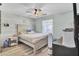 Cozy bedroom with light wood-look flooring, ceiling fan, and natural light at 1861 Jaywood Cir, Charleston, SC 29407