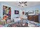 Bedroom with light blue walls, ceiling fan, TV, and doorway leading to an adjacent room at 1861 Jaywood Cir, Charleston, SC 29407