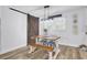 This dining area features a wooden table and chairs, a rustic sliding barn door, and a charming light fixture at 1861 Jaywood Cir, Charleston, SC 29407