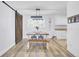 Charming dining area with a rustic wooden table, industrial lighting, and a barn door accent at 1861 Jaywood Cir, Charleston, SC 29407