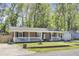 Inviting home showcasing a brick facade, a welcoming front porch, and a well-manicured lawn at 1861 Jaywood Cir, Charleston, SC 29407