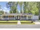 Charming brick and siding home featuring a quaint front porch and well-maintained landscaping at 1861 Jaywood Cir, Charleston, SC 29407