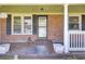 Welcoming front porch with brick accents, decorative signage, and a cozy ambiance at 1861 Jaywood Cir, Charleston, SC 29407