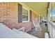 A charming brick porch featuring classic details and a cozy rocking chair for relaxation at 1861 Jaywood Cir, Charleston, SC 29407